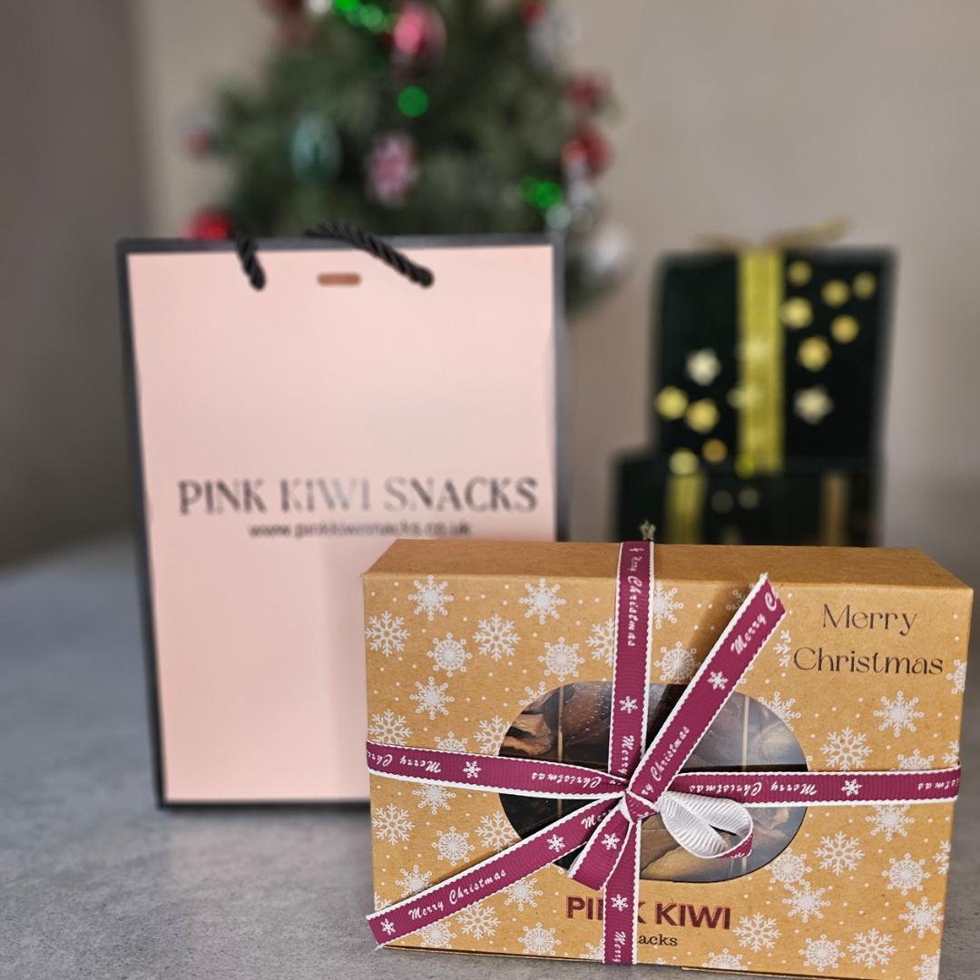 Pink Kiwi Snacks festive Christmas gift box with ribbon and branded shopping bag, perfect for healthy holiday gifting