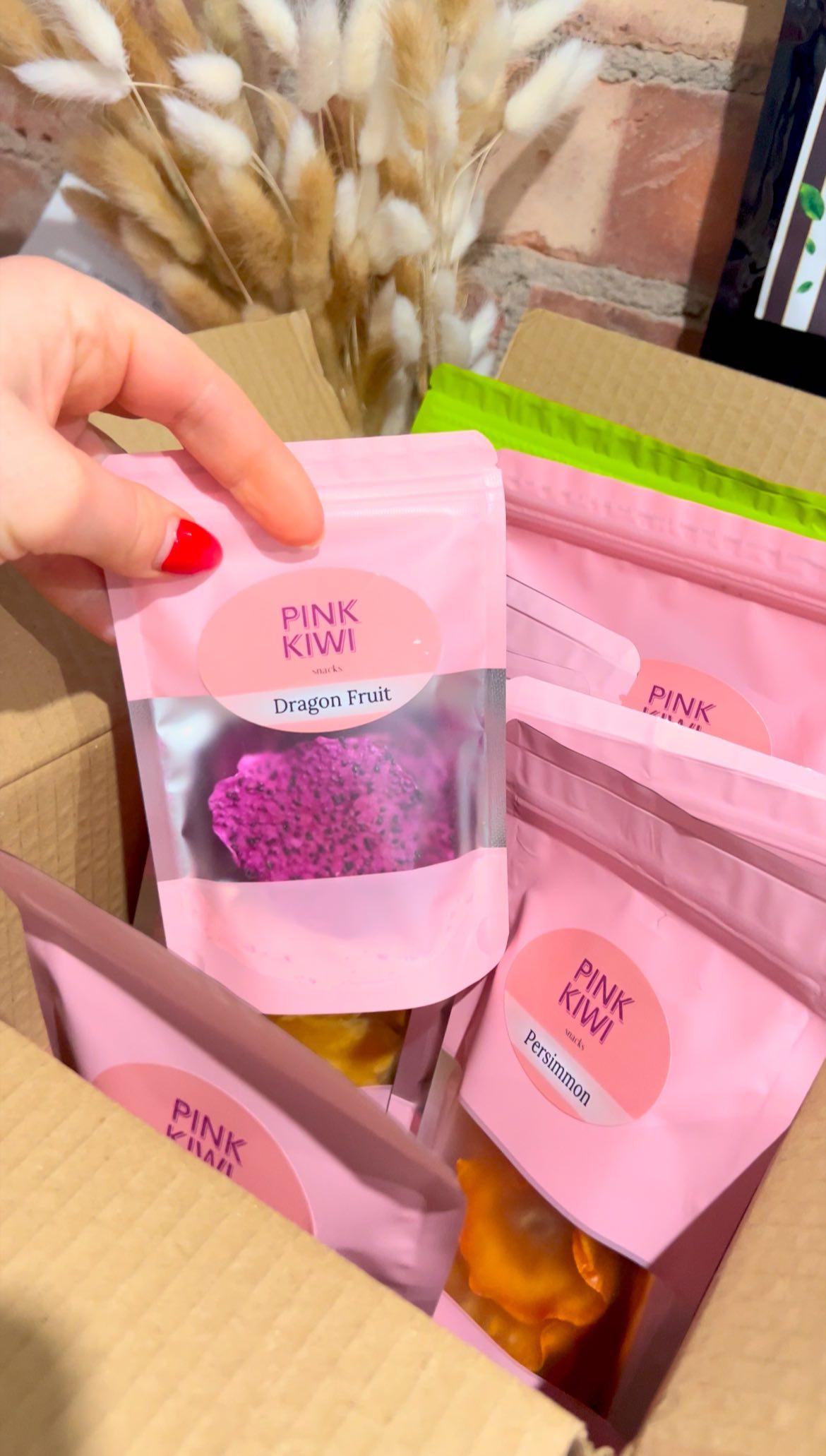 Unboxing Pink Kiwi snack box filled with natural dried dragon fruit and other fruity snacks, perfect for healthy gifting or mindful snacking.
