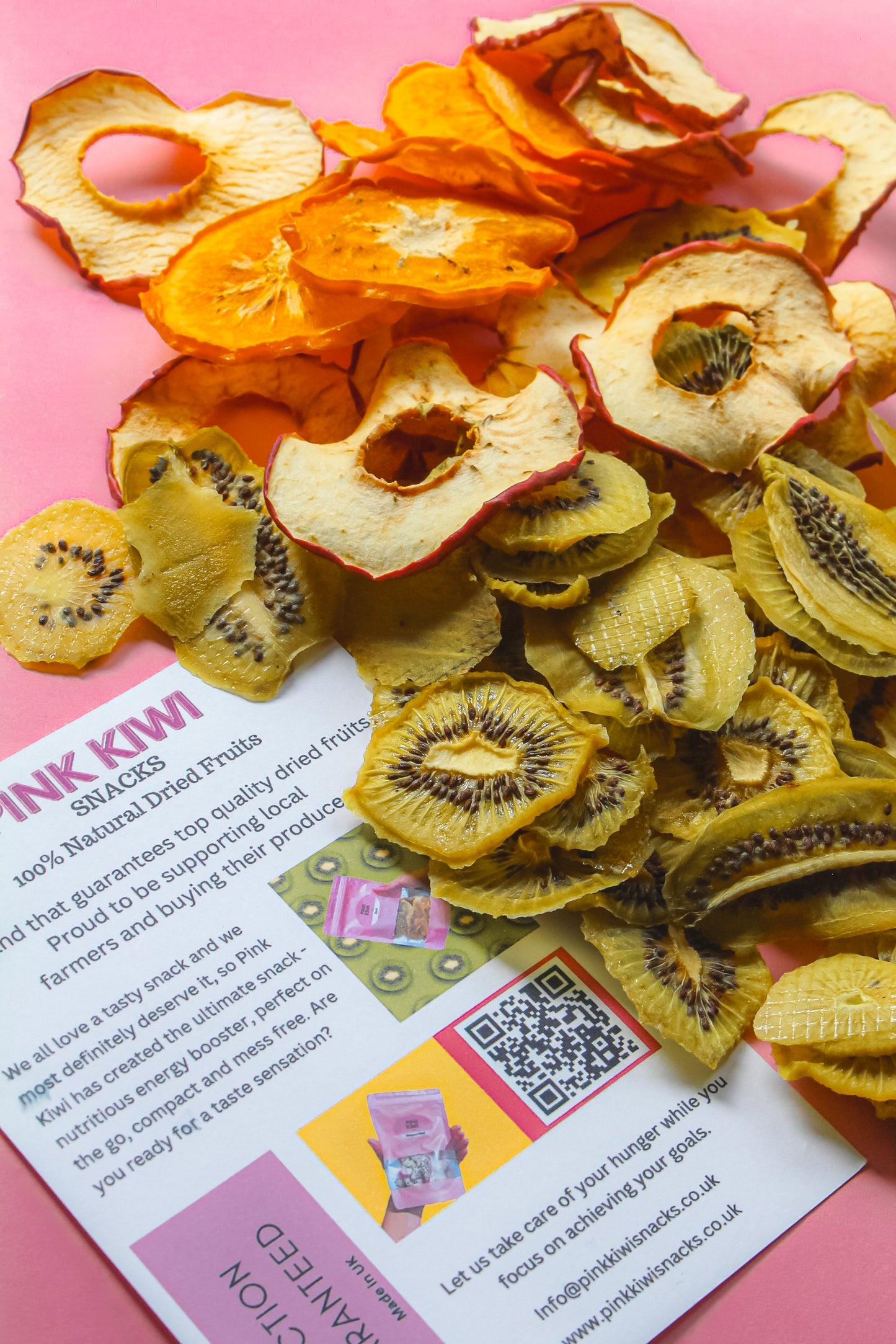 Pink Kiwi Snacks flyer with a colorful spread of dried apple, kiwi, and sweet potato chips on a pink background.
